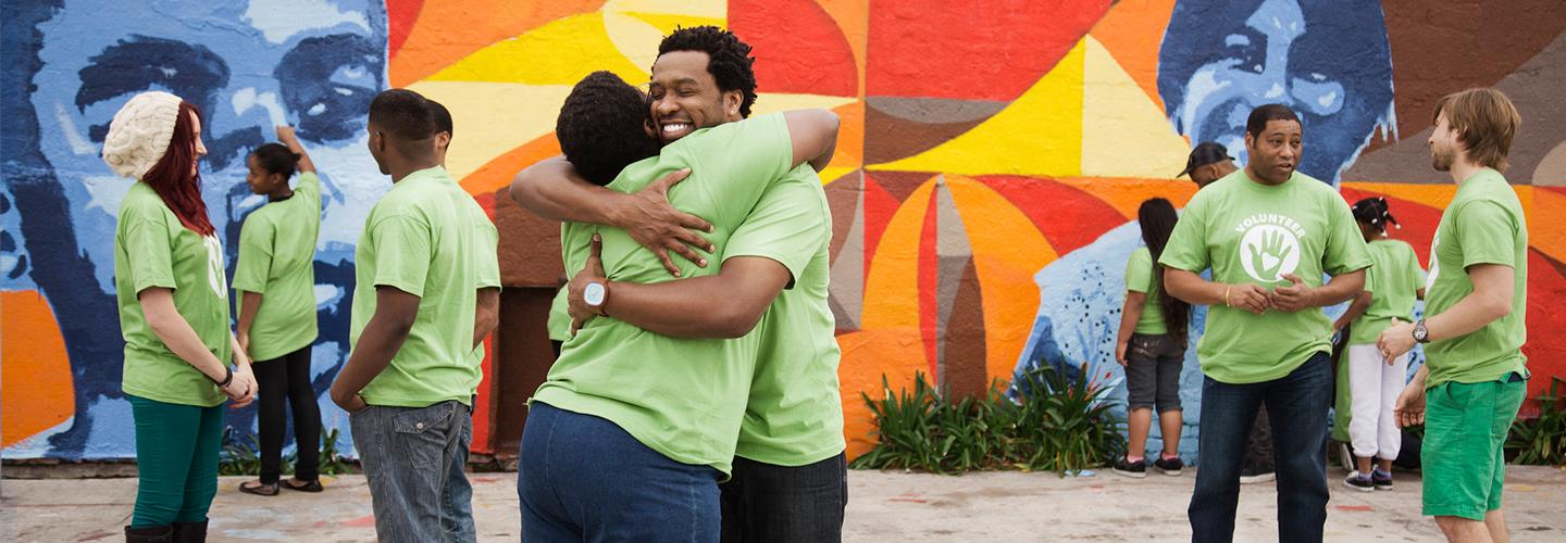 a group of volunteers hugging