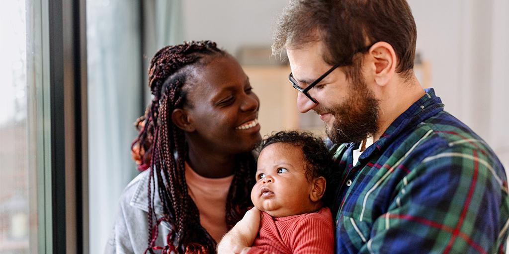 a couple holds their child