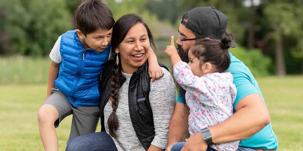 a native american family smiles together