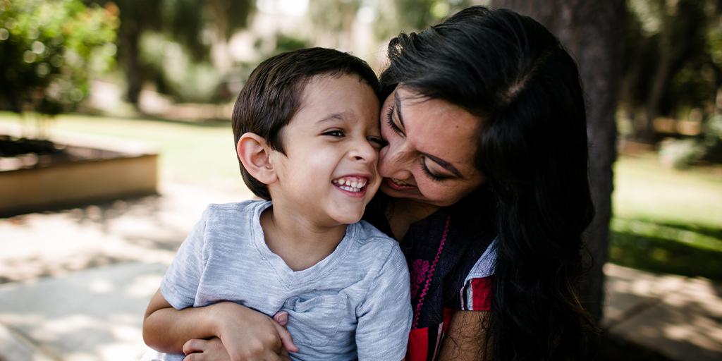 a mother hugs her son