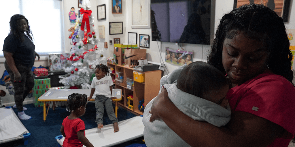 daycare teacher comforts baby