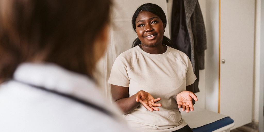 a young woman talking to her doctor