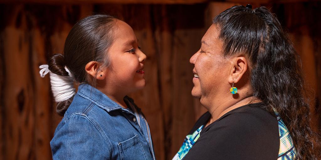 a grandmother holds her granddaughter