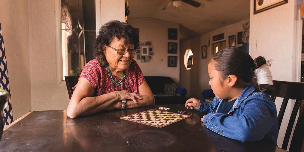 a grandmother plays a game with her grandchild