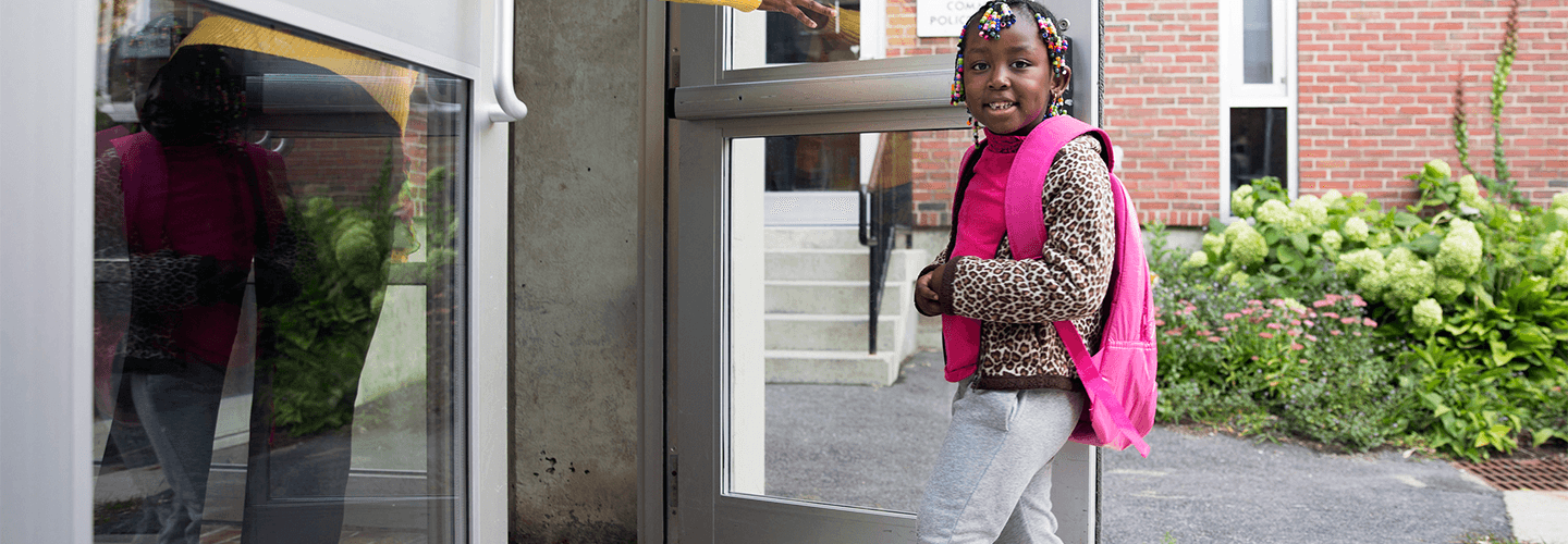 Young girl walking into school