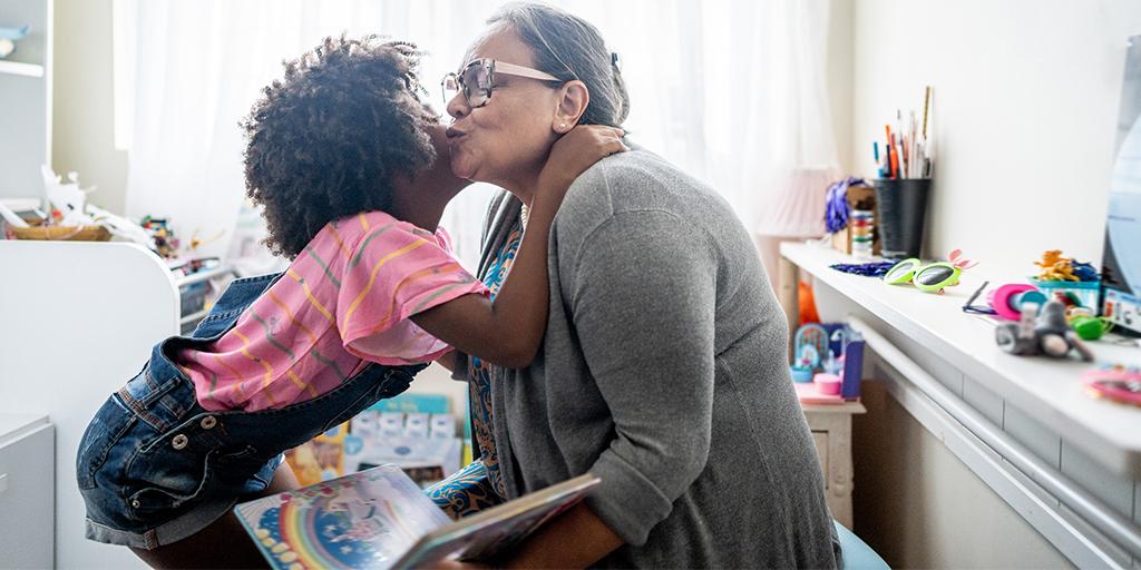 a girl hugs her grandmother