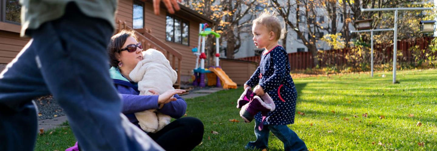 a young girl is outside with her parents